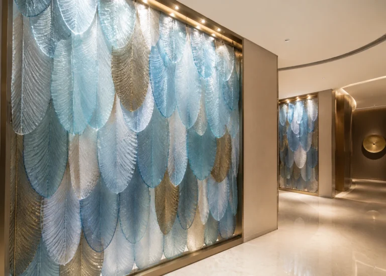 Full-height feather and leaf crystal feature wall shown as a hotel lobby design reference