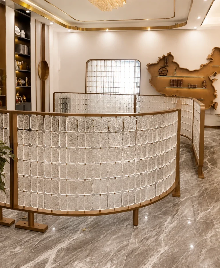 Curved half-height crystal screen creating a visual boundary around a seating area
